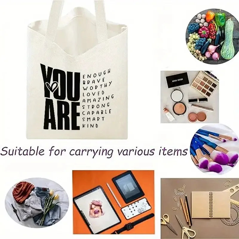 A white canvas shoulder tote bag featuring the inspirational quote YOU ARE printed in black text.