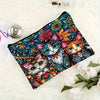 A vibrant, colorful makeup pouch featuring a detailed cat design, set against a white fluffy background.