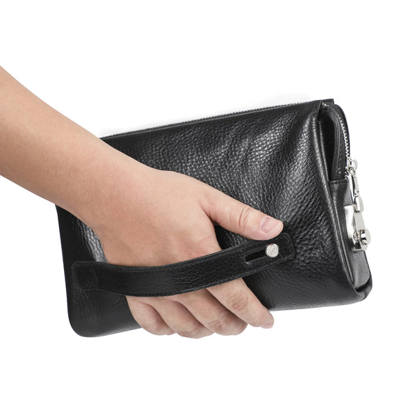 A hand is holding a black genuine leather men's clutch wallet.