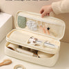 A light beige flip style large opening storage bag for a hair dryer, showing partitioned compartments and a wooden brush.