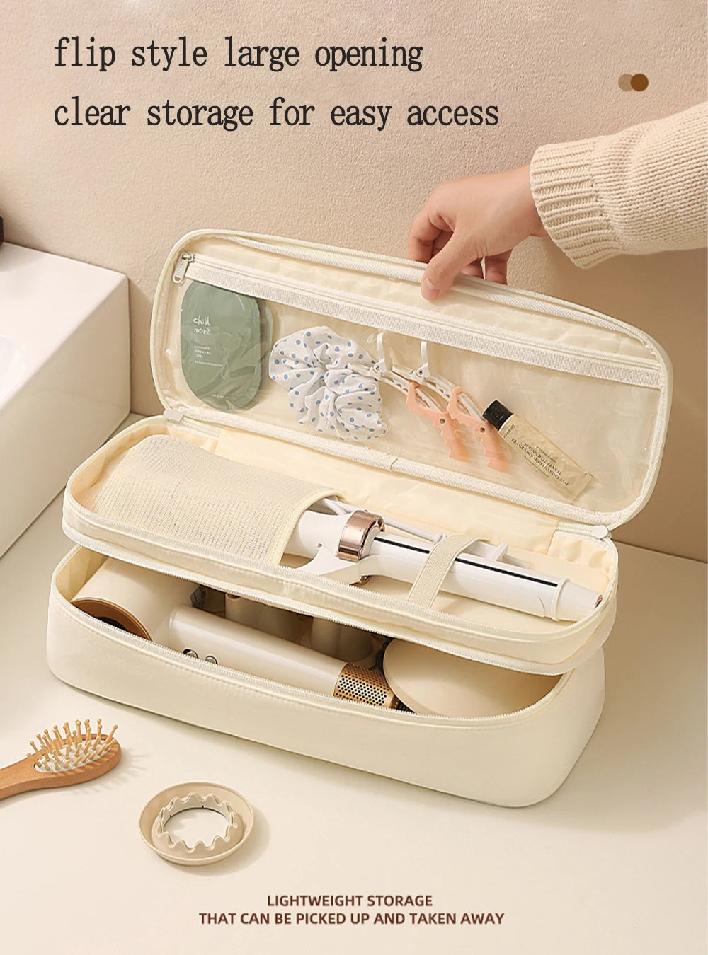 A light beige flip style large opening storage bag for a hair dryer, showing partitioned compartments and a wooden brush.