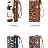 A display of five leopard print clutch wallets in various colors including cow brown, leopard brown, leopard black, and leopa