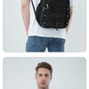 A man wearing a black fashion mesh backpack on his back, shown in a model show context.