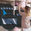 A person is using clear garment dust covers on hangers inside a closet shelf.