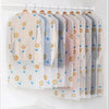 Clear garment dust covers for hangers featuring a pattern of small yellow and blue animal faces