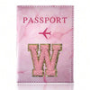 Pink marbled passport cover featuring a gold initial W embossed on the front.