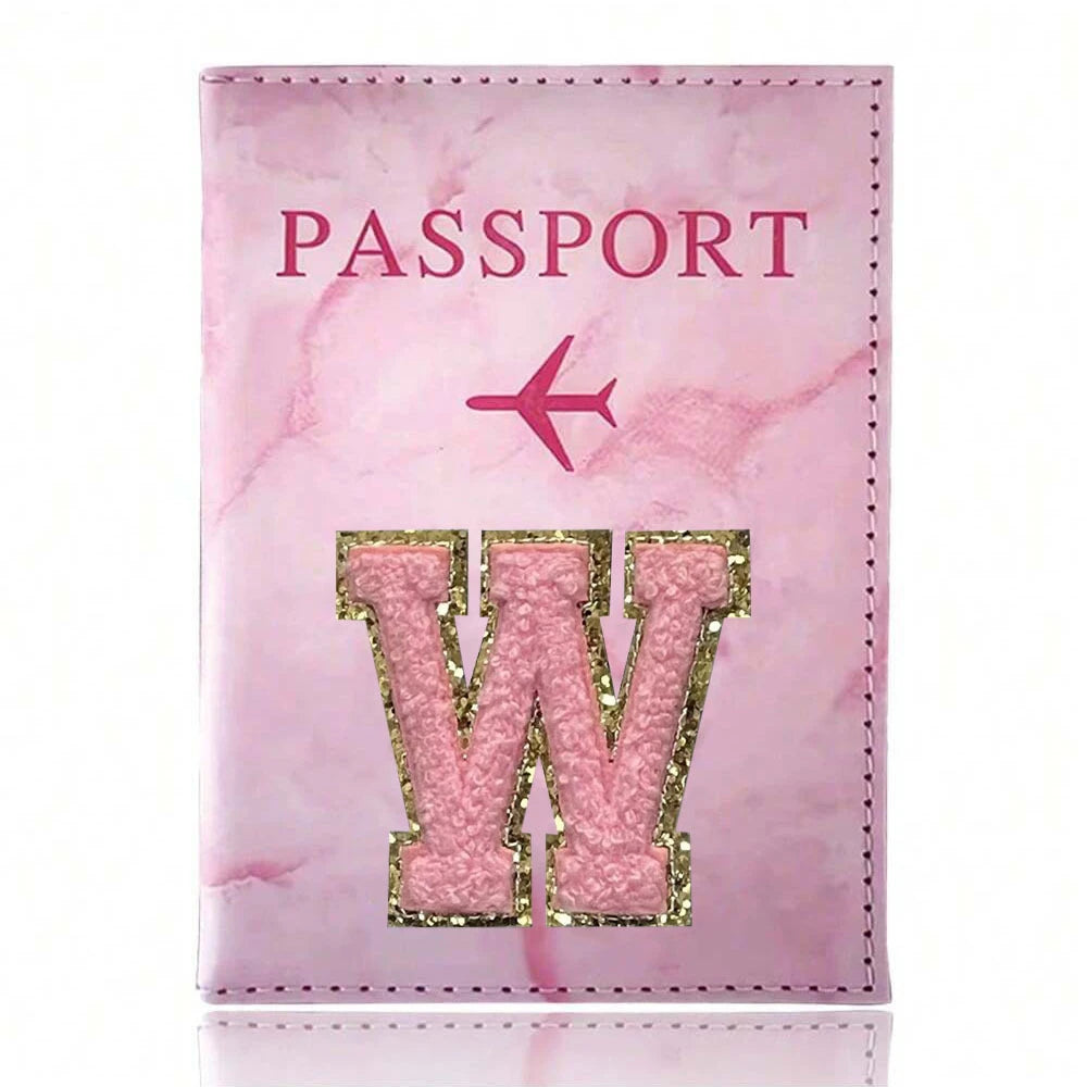 Pink marbled passport cover featuring a gold initial W embossed on the front.
