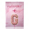 Pink marbled passport cover featuring a gold embossed letter G and a pink airplane symbol