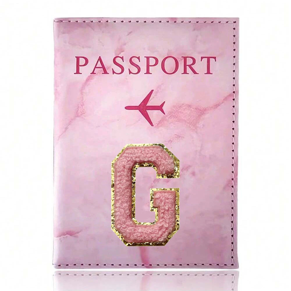 Pink marbled passport cover featuring a gold embossed letter G and a pink airplane symbol