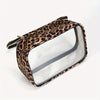 A leopard print clear cosmetic bag with a gold zipper, shown from above.