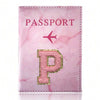 Pink marbled passport cover featuring a gold initial P and an airplane symbol