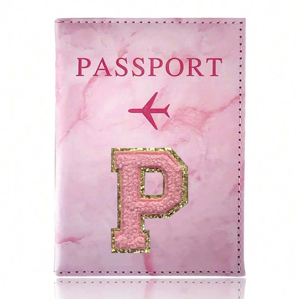 Pink marbled passport cover featuring a gold initial P and an airplane symbol