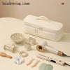 A white storage bag for hairdressing items is shown with various tools like a hair dryer and styling tools laid out on a tabl