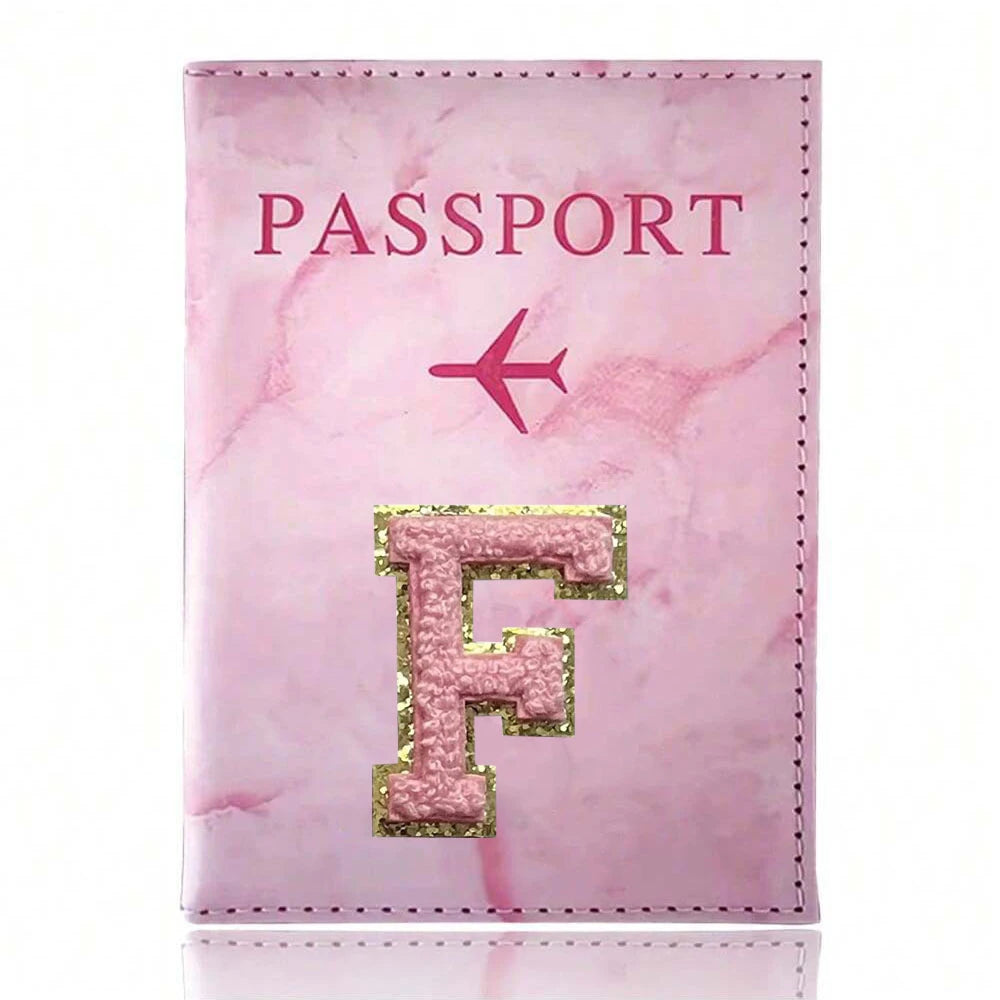 Pink marbled passport cover featuring a gold initial F and a pink airplane design.