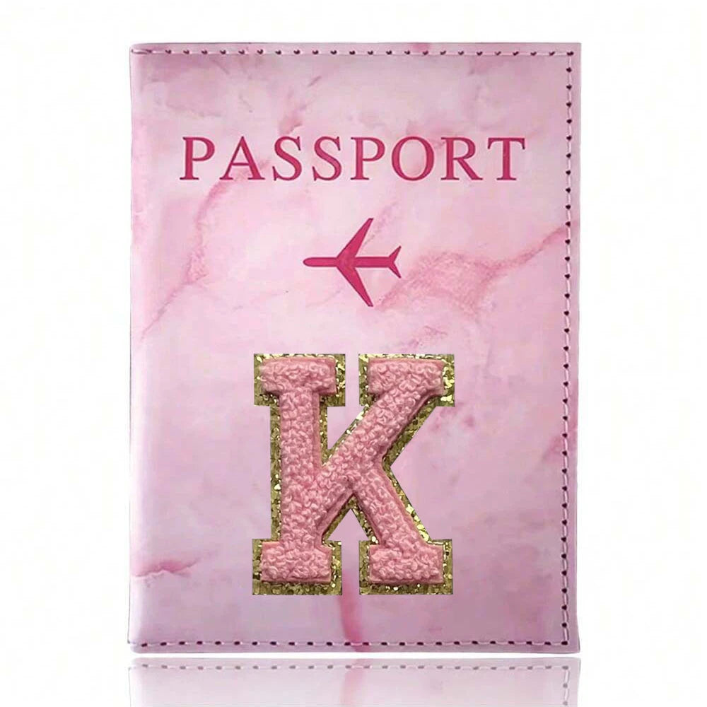 Pink marbled passport cover featuring a gold embroidered letter K