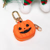 Porta-monedas en forma de calabaza naranja con cara tallada en negro y herrajes dorados