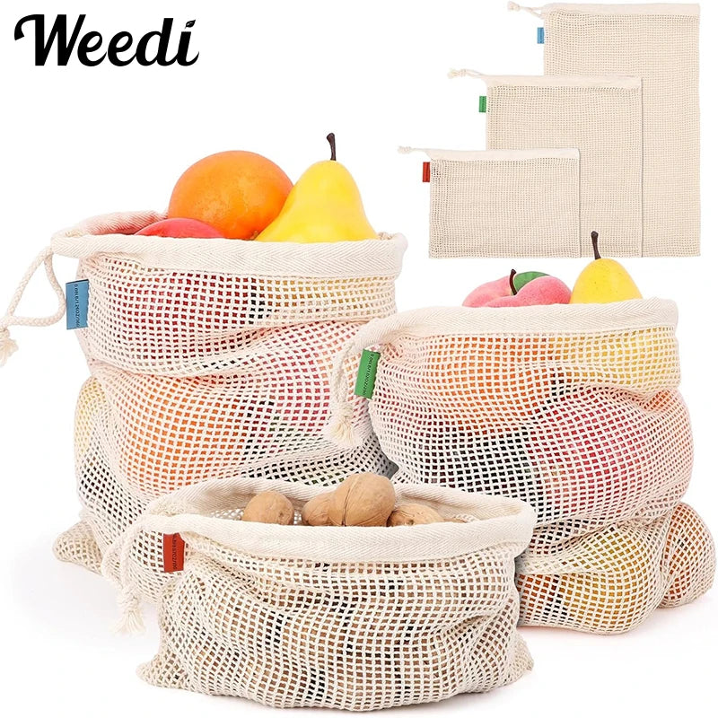 Reusable cotton mesh produce bags filled with fruits like oranges and lemons