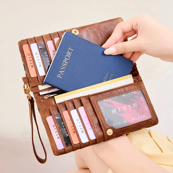 A brown leather passport holder wallet with multiple card slots and a blue passport visible.