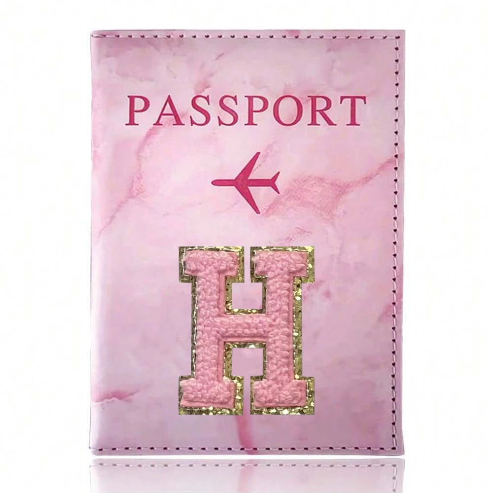 Pink marbled passport cover featuring a gold embroidered letter H