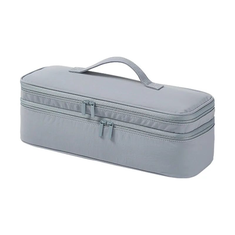 A gray durable travel hair dryer storage bag with a handle and partitioned compartments.