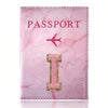 A pink marbled leather passport cover featuring gold embroidery of the letter I