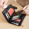 A black women's wallet with a gold zipper features multiple card slots and a leopard print design.
