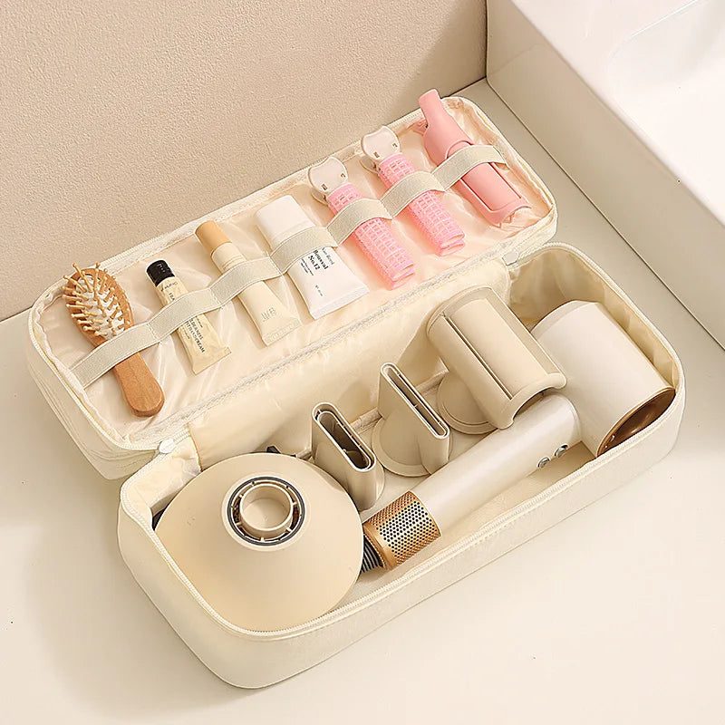 A beige storage bag for travel hair dryers and styling tools with partitioned compartments.