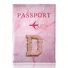 Pink marbled passport cover with a gold initial D embossed on the front