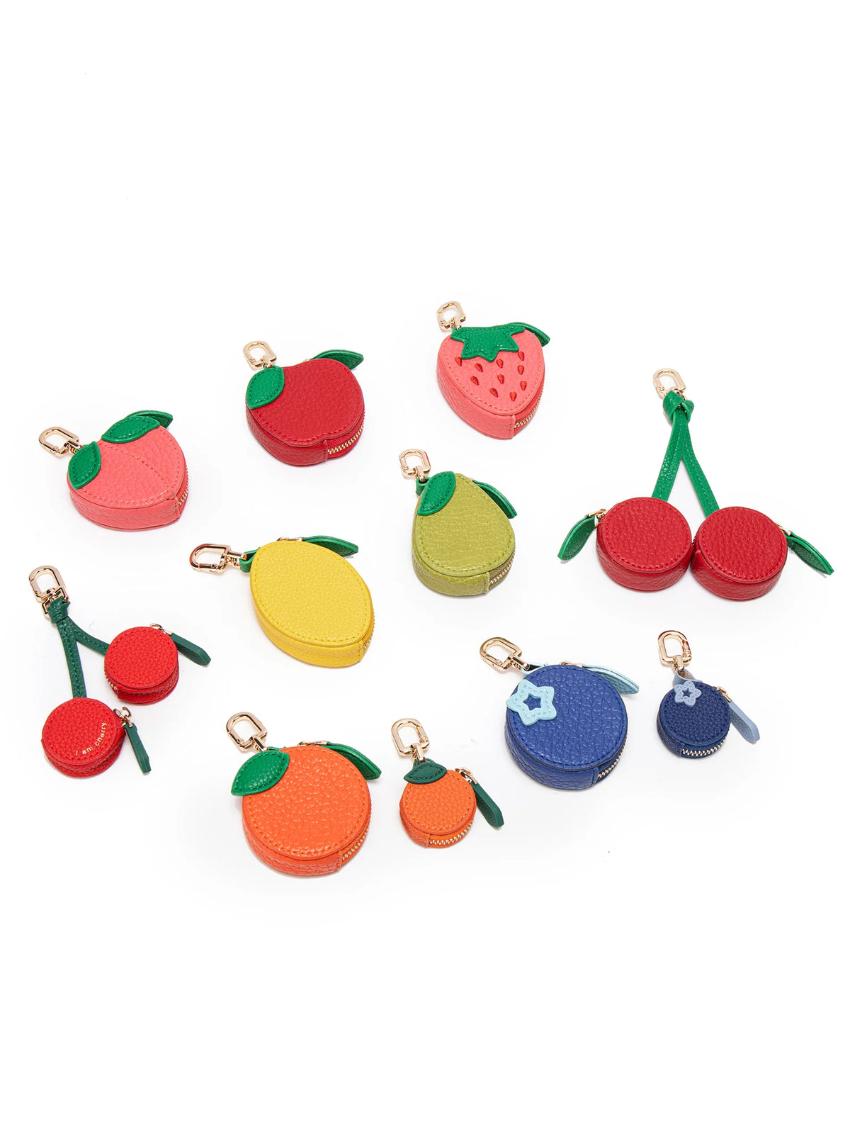 A collection of fruit-shaped coin purse keychains in red, green, and yellow colors.