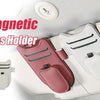 A collection of Strong Magnetic Car Visor Glasses Holders in various colors resting on a light-colored surface.