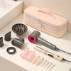 A pink storage bag for a hair dryer, next to various hair styling tools and accessories.