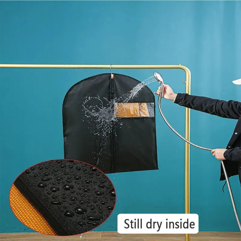 A black garment dust cover is being sprayed with water on a gold-colored rod, demonstrating the product's function.