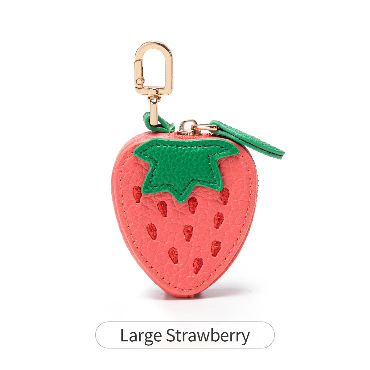 A large strawberry coin purse keychain with a pink body and green leaves.