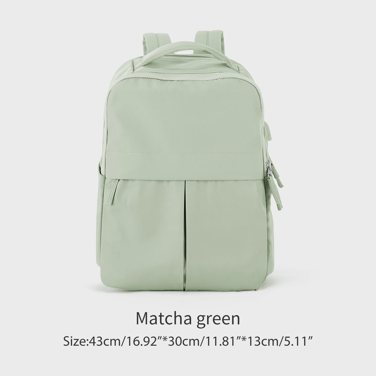 A light green laptop backpack with a top handle and zippered compartments.