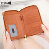 A brown leather RFID blocking travel wallet is shown being held by a hand, featuring a zipper and a key attached.