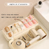 A beige storage bag for hair dryer accessories showing elastic straps holding various small items like brushes and dryers.