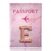 Pink marbled passport cover featuring a gold embroidered letter E