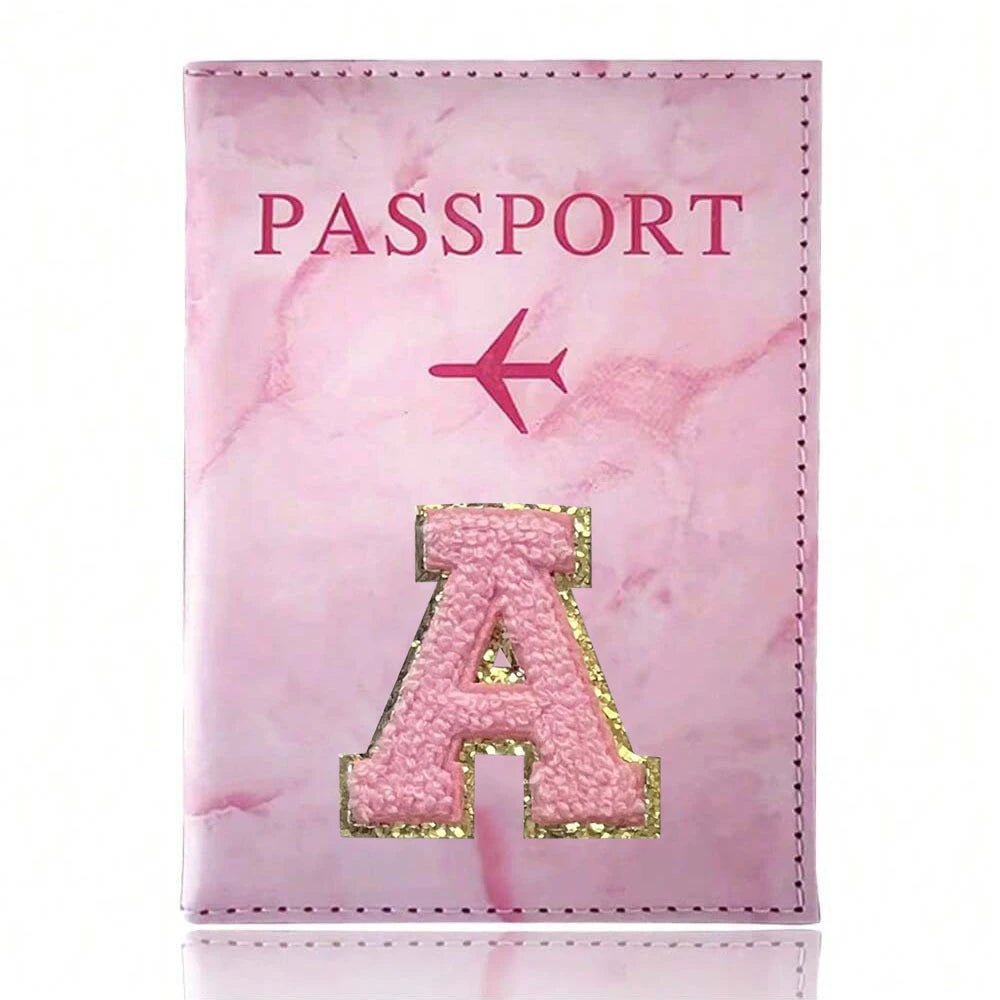 Pink marbled passport cover featuring a pink airplane and a gold embroidered letter A