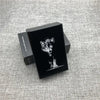 A black custom engraved cigarette case featuring a detailed image of a wolf's face on a gray textured surface.
