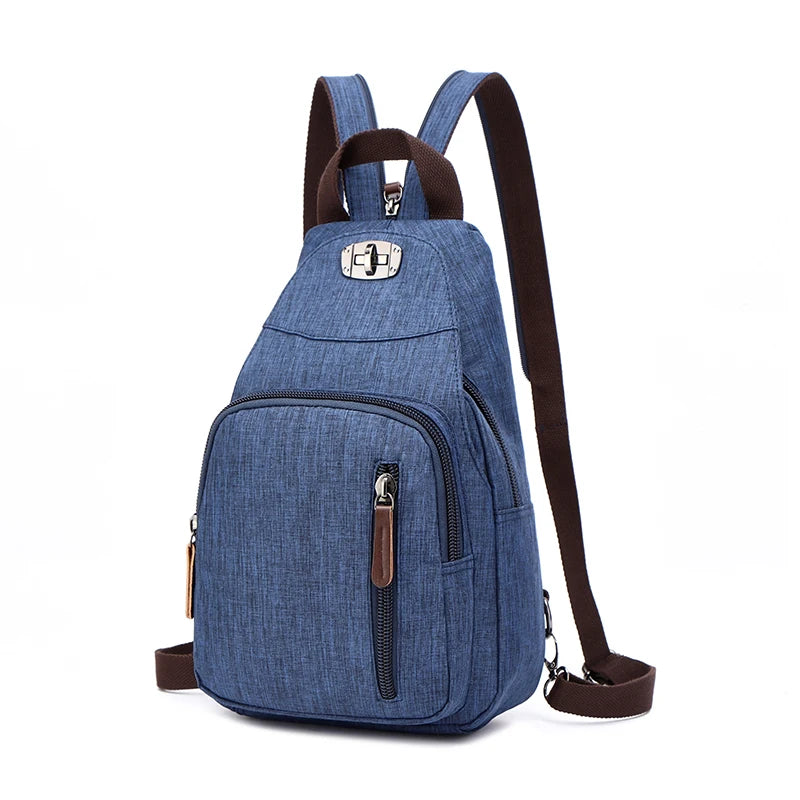 A dark blue canvas backpack with brown straps and a silver buckle detail.