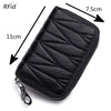 Black genuine leather RFID women's travel wallet with zipper closure shown from above.