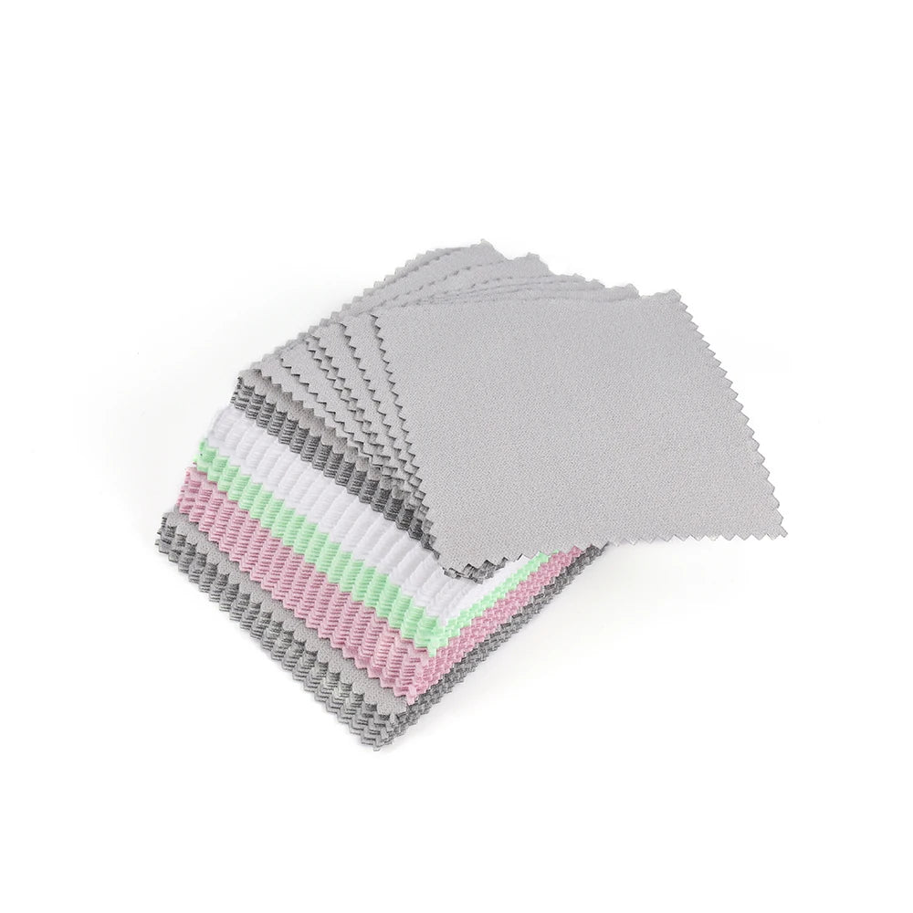 A stack of polishing cloths featuring various shades of silver, gold, and pink.