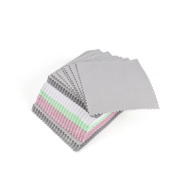 A stack of polishing cloths featuring various shades of silver, gold, and pink.
