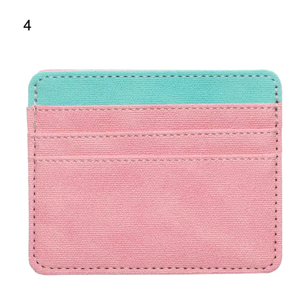 A pink and turquoise PU leather card holder wallet with a stitched edge.
