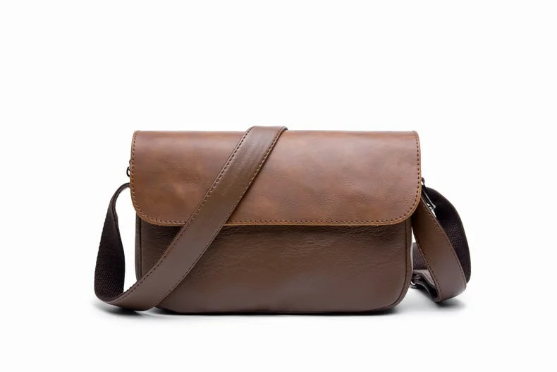 A brown retro PU leather crossbody shoulder bag with a leather strap shown against a white background.