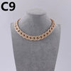 A close-up of a beige acrylic link chain necklace displayed on a mannequin neck.
