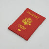 A red leather passport holder with gold lettering and an embossed eagle design.