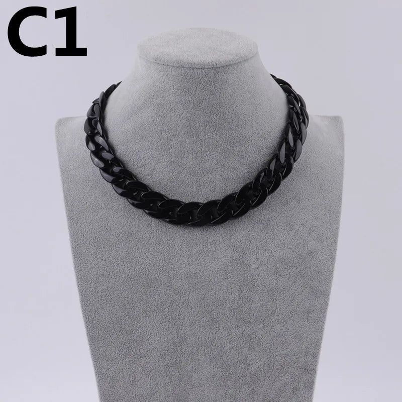 A black acrylic link chain necklace displayed on a mannequin neck.