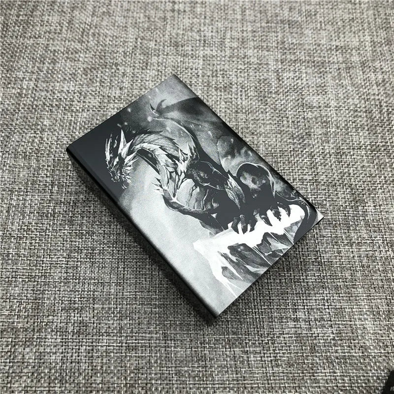 A black custom engraved cigarette case featuring a monochrome design of a fierce dragon.