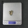 Silver digital thermometer with a vintage brass rat figurine on the display